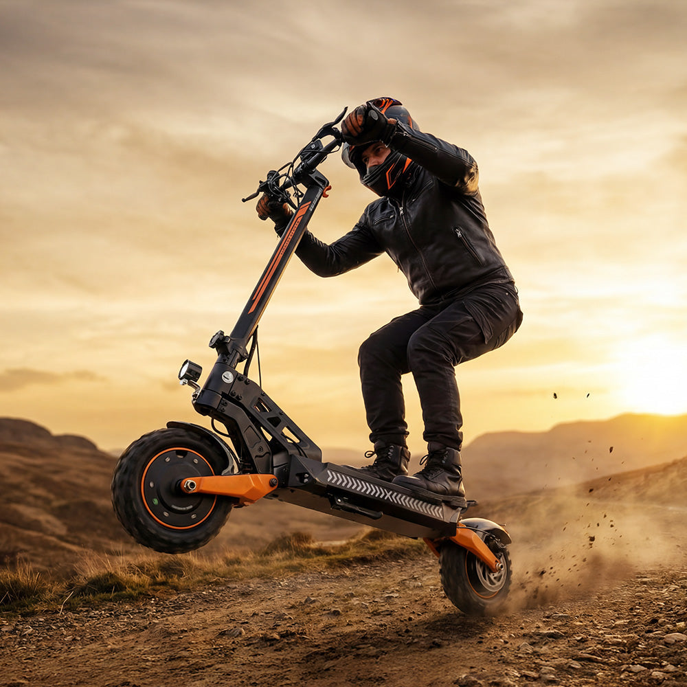 A rider in full gear performing a wheelie on an off-road electric scooter in a rugged landscape at sunset.