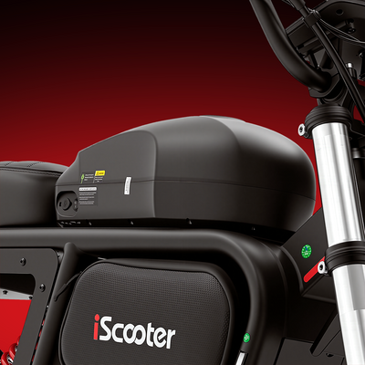 Close-up of the iScooter DX5 Max removable battery compartment, showing the integrated battery pack mounted beneath the seat within the frame. The image highlights the bike’s detachable battery design for convenient charging and extended riding flexibility.