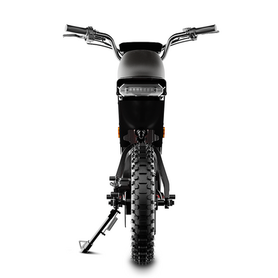 A front-facing studio product image of a black electric bike on a white background. The bike features a wide fat tire, integrated LED headlight, raised handlebars, front suspension fork, and a side kickstand. The symmetrical front view highlights the bike’s rugged tire tread, sturdy frame design, and urban-meets-off-road styling.