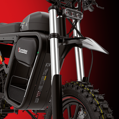 Close-up of an electric scooter’s front suspension system with dual shock absorbers and an off-road tire for improved comfort and stability on rough terrain.
