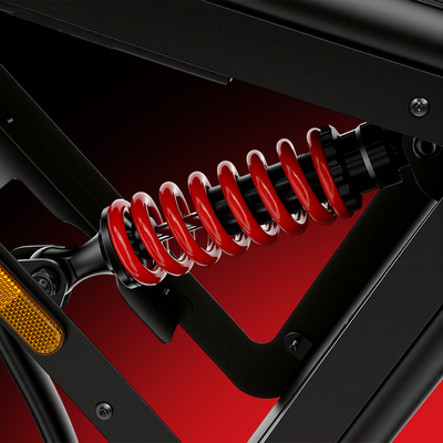 Close-up of the iScooter DX5 Max rear suspension system, featuring a red coil spring shock absorber mounted within the black frame. The image highlights the bike’s suspension design for enhanced comfort and stability on rough terrain.