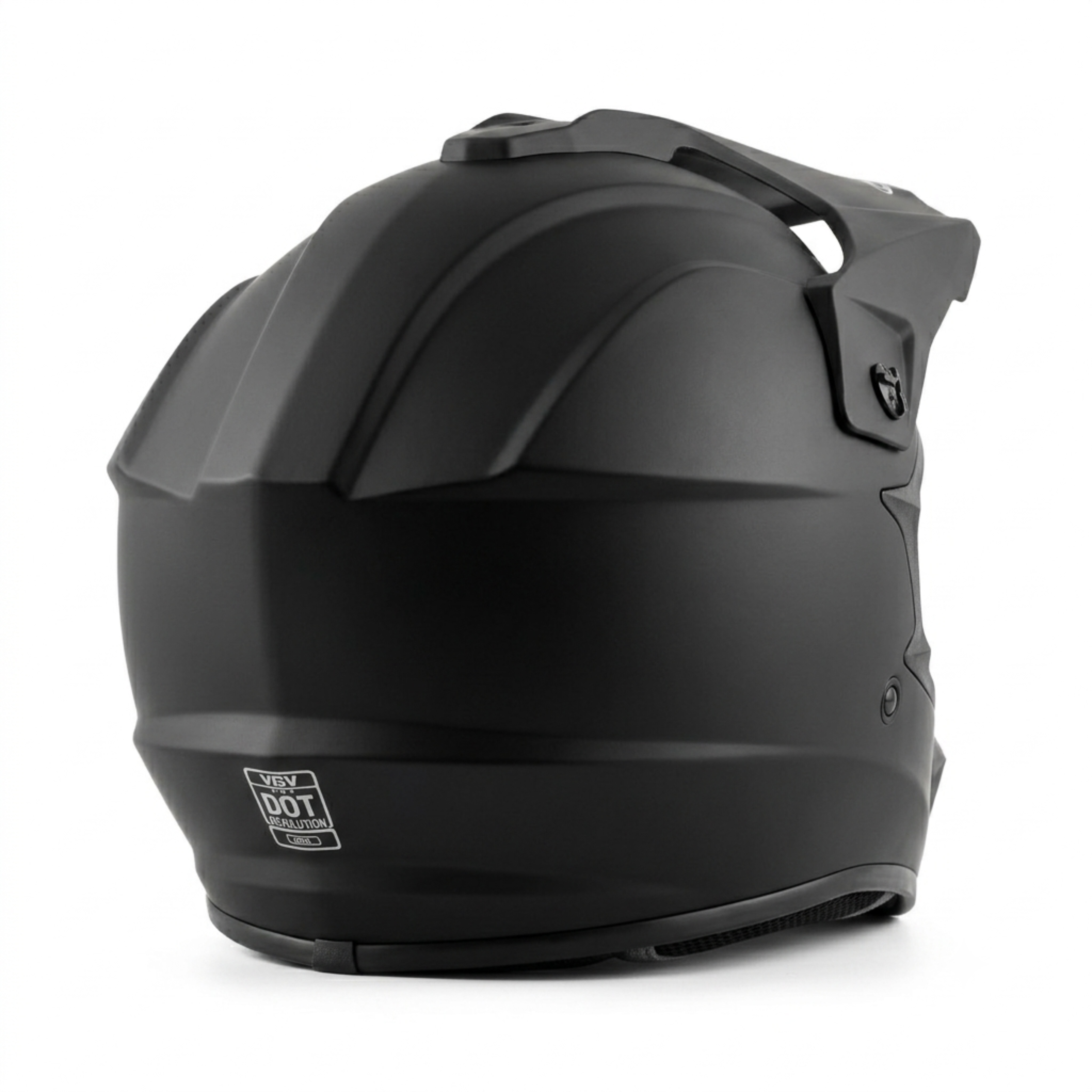 Rear-three-quarter view of a matte black full-face dirt bike helmet, featuring integrated top ventilation, a sun visor peak, and a prominent white DOT safety certification emblem printed at the bottom back center.