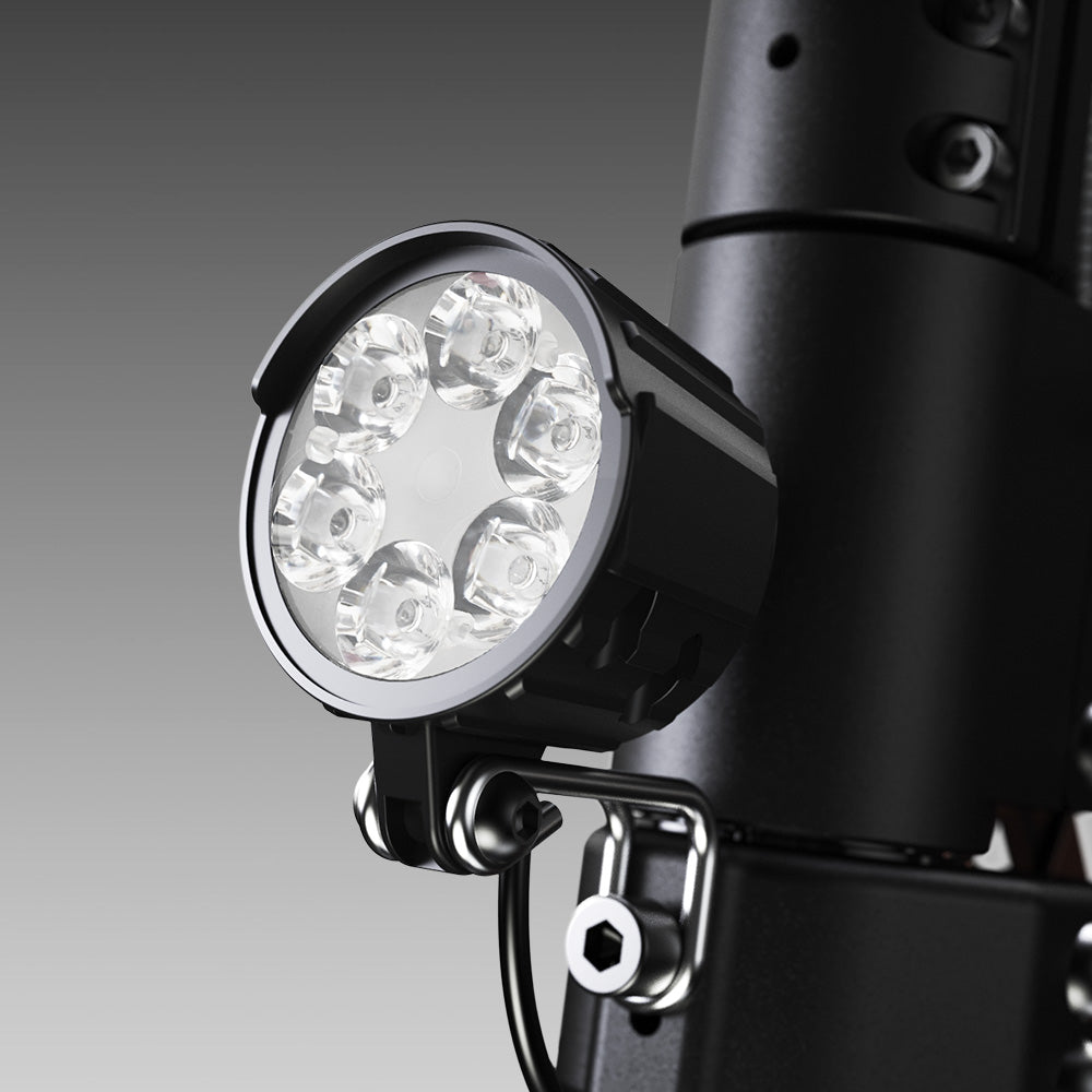 Close-up of the iScooter W12 front LED headlight mounted on the handlebar stem, featuring a multi-lens design for bright illumination and enhanced visibility during night riding.