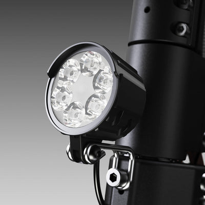 Close-up of the iScooter W12 front LED headlight mounted on the handlebar stem, featuring a multi-lens design for bright illumination and enhanced visibility during night riding.