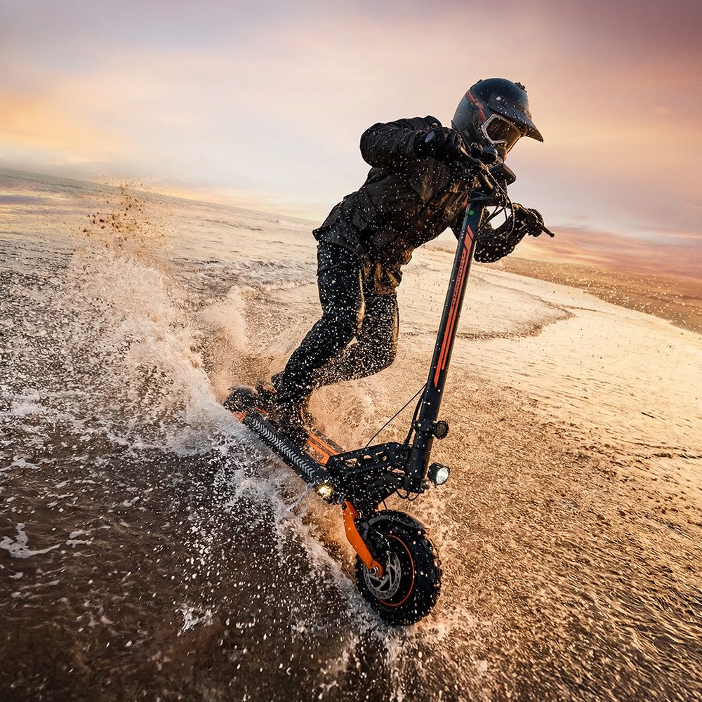 Off-road electric scooter riding through water at sunset, showcasing all-terrain tyres, suspension system, and durable performance in wet and challenging riding conditions